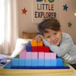 Pyramid Lifestyle 1 boy next to a large colourful wooden pyramid block set